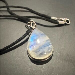 Genuine Moonstone pendant in sterling silver setting w/black rope necklace.